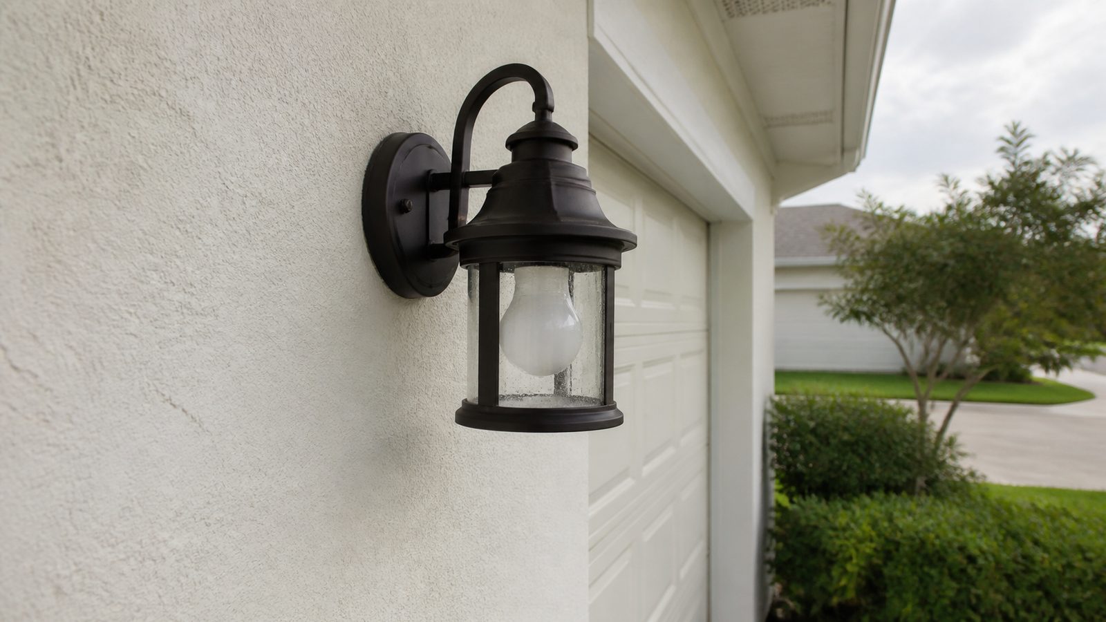 Exterior wall sconce mounted on a clean wall with a neat weather-sealed perimeter
