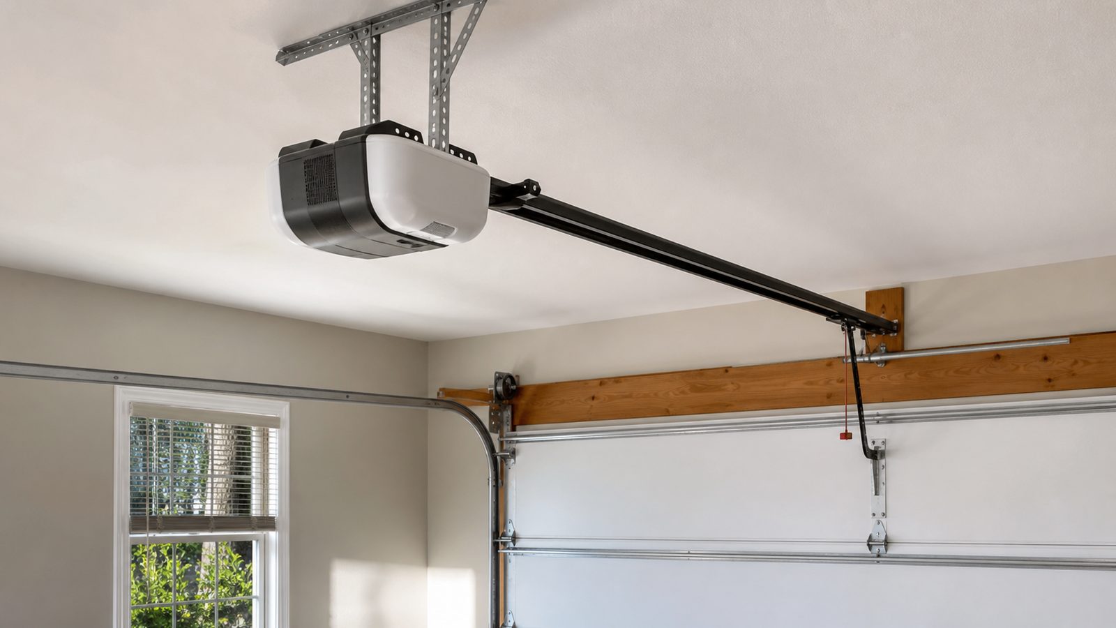 Ceiling-mounted garage door opener with straight rail, trolley, and sectional door